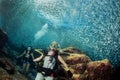 Beautiful diver in fish and corals reef background Royalty Free Stock Photo