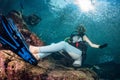 Beautiful diver in fish and corals reef background Royalty Free Stock Photo