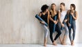Beautiful diverse girls with yoga mats chatting and laughing