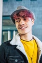 Beautiful diversity young people concept with caucasian cheerful coloured hair teenager male with urban wall in background - Royalty Free Stock Photo