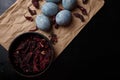 Beautiful DIY painted Easter eggs, dry Hibiscus tea in black bowl. Easter black wooden background. Top view, copy space Royalty Free Stock Photo