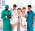 Beautiful doctor with her team in the background Royalty Free Stock Photo