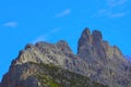 Beautiful Dolomites in Italy. Clear day with blue sky. Part of the mountains is covered with green vegetation. Selective focus Royalty Free Stock Photo