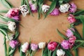 Beautiful double peony tulips frame flat lay on wooden table, space for text. Colorful pink and purple tulips. Happy mother`s day Royalty Free Stock Photo