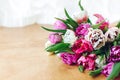 Beautiful double peony tulips on wooden table with copy space. Colorful pink and purple tulips bouquet. Happy mothers day.