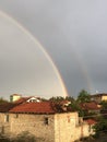 Beautiful double rainbow after the rain in a village