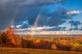 Beautiful double rainbow during sunrise in a countryside field in Northwest Pennsylvania
