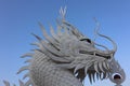 A beautiful dragon sculpture made of cement stands in a Thai temple. Royalty Free Stock Photo