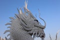 A beautiful dragon sculpture made of cement stands in a Thai temple. Royalty Free Stock Photo