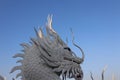 A beautiful dragon sculpture made of cement stands in a Thai temple. Royalty Free Stock Photo