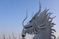 A beautiful dragon sculpture made of cement stands in a Thai temple. Royalty Free Stock Photo