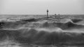 Beautiful dramatic black and white stormy landscape image of waves crashing onto beach at sunrise Royalty Free Stock Photo