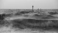 Beautiful dramatic black and white stormy landscape image of waves crashing onto beach at sunrise Royalty Free Stock Photo