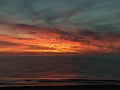 Beautiful dramatic golden sky over the sea, reflection at sunset time, long exposure Royalty Free Stock Photo