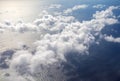 Beautiful, dramatic a group of clouds in the sky over the ocean viewed from a height from inside an airplane Royalty Free Stock Photo