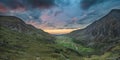 Beautiful dramatic landscape image of Nant Francon valley in Snowdonia during sunset in Autumn