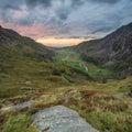 Beautiful dramatic landscape image of Nant Francon valley in Snowdonia during sunset in Autumn