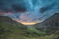 Beautiful dramatic landscape image of Nant Francon valley in Snowdonia during sunset in Autumn