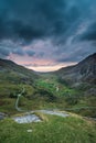 Beautiful dramatic landscape image of Nant Francon valley in Snowdonia during sunset in Autumn