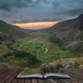 Beautiful dramatic landscape image of Nant Francon valley in Snowdonia during sunset in Autumn coming out of pages of open story