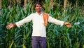 Beautiful dramatic portrait of Indian rural happy farmer standing in field wearing shirt pant in summer time