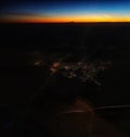 Sunset from plane with city lights