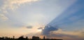 Dramatic sky clouds with light rays over the city at sunset time. Natural landscape for background Royalty Free Stock Photo