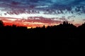 Beautiful dramatic sky colorful orange clouds sunset over forest silhouette. Landscape panoramic view. Royalty Free Stock Photo