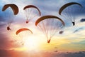 Silhouette Of Paragliders At Sunset