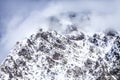 Beautiful dramatic snowy Caucasus mountain peaks in clouds. Scenic winter landscape Royalty Free Stock Photo
