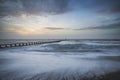 Beautiful dramatic stormy landscape image of waves crashing onto Royalty Free Stock Photo