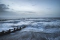 Beautiful dramatic stormy landscape image of waves crashing onto Royalty Free Stock Photo