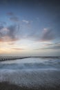 Beautiful dramatic stormy landscape image of waves crashing onto Royalty Free Stock Photo