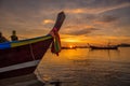 Beautiful dramatic sunrise at Rawai beach with andaman long tail