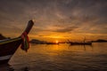 Beautiful dramatic sunrise at Rawai beach with andaman long tailed boat southern of thailand floating on clear sea water with sun