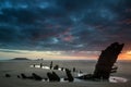 Beautiful dramatic sunset landscape over shipwreck on Rhosilli B