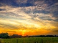 Beautiful dramatic sunset over a field Royalty Free Stock Photo