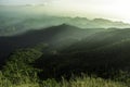 Beautiful dramatic sunset sky clouds over the rocky mountain top view covered by green forest nature background Royalty Free Stock Photo