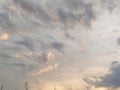 Beautiful dramatic sunset. The sky turned yellow. Dark gray clouds. Clouds lit by the lateral evening sun. Soft warm tones Royalty Free Stock Photo