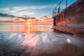 Beautiful dramatic warm sunrise on the beach with a clear blue and orange sky Royalty Free Stock Photo