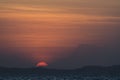 Beautiful dramatic yellow and orange sunset falling behind the mountains