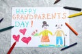 Beautiful drawing on grey marble table, flat lay. Happy Grandparents Day