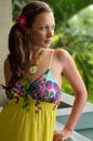 Beautiful dreaming girl on the balcony in a yellow sundress Royalty Free Stock Photo