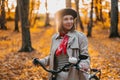 Beautiful dreamy portrait of young smiling woman in french beret cycling alone in park. Sunny day in forest. Trendy lady Royalty Free Stock Photo