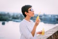 Beautiful dreamy woman blowing soap bubbles outdoor Royalty Free Stock Photo