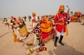 Beautiful dressed musician with saxophone & camel