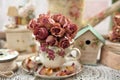 Dried roses in vintage style porcelain cup