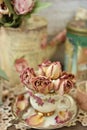 Dried roses in vintage style porcelain cup