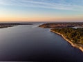 Beautiful drone areal photography view of large dune and pine forest near river Lielupe. Photo taken on sunset, Europe, Latvia