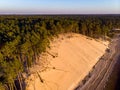 Beautiful drone areal photography view of large dune and pine forest near river Lielupe.